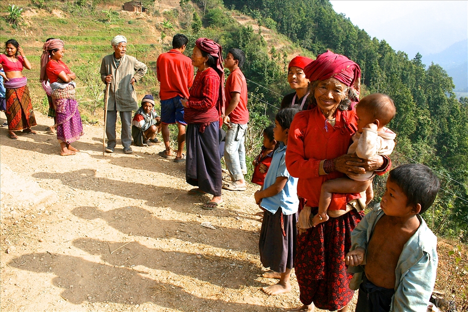 A group of Chepang people congregate on the edge of their Himalayan foothills  village in the Chitwan district of Nepal. On this momentous day, some of them received their citizenship documentation. 

The Chepang are a semi-nomadic indigenous group considered to be the poorest of the poor in Nepal. Isolated from modern facilities and services, and largely lacking in education, they spent their lives without access to basic rights. In absence of citizenship certificates, the Chepang people were not able to vote, access various public services such as electricity, and enroll their children in the local schools. 