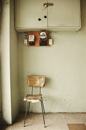 SOLITUDE A worn and expectant chair; the start of a new day. The Laundromat is a silent meeting place for people of all walks of life. A common ground, where mutual respect is established and common societal boundaries are dissolved. This chair sees all who come in and out, and by the look of it, becomes intimate with many. The chair is weary, but also refelcts a peaceful calm. A perfect metaphor for the laundromat itself.