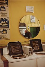 REFLECTION 
An elderly man quietly loads his washing into a machine, unaware of his humble observer.
: by maggiebeatrice, Views[2078]