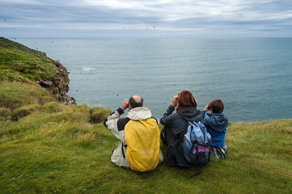 Puffin spotting with binoculars for the whole family in the part of the cliff that faces Atlantic Ocean.