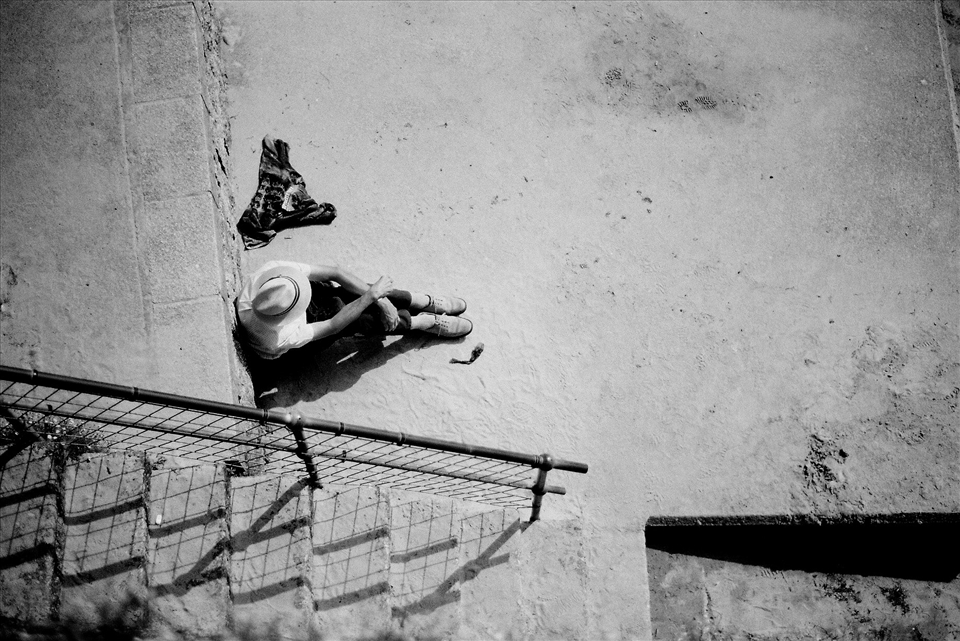 From Above:While shuffling through the crowds and think that it would be nice to get away somewhere more quit. I looked down to see a man sat in peace looking out towards the sea. I never saw his face but I felt I didn't have to, I decided to capture that perspective of him as I felt it best revealed his character. Through his body language and clothing.