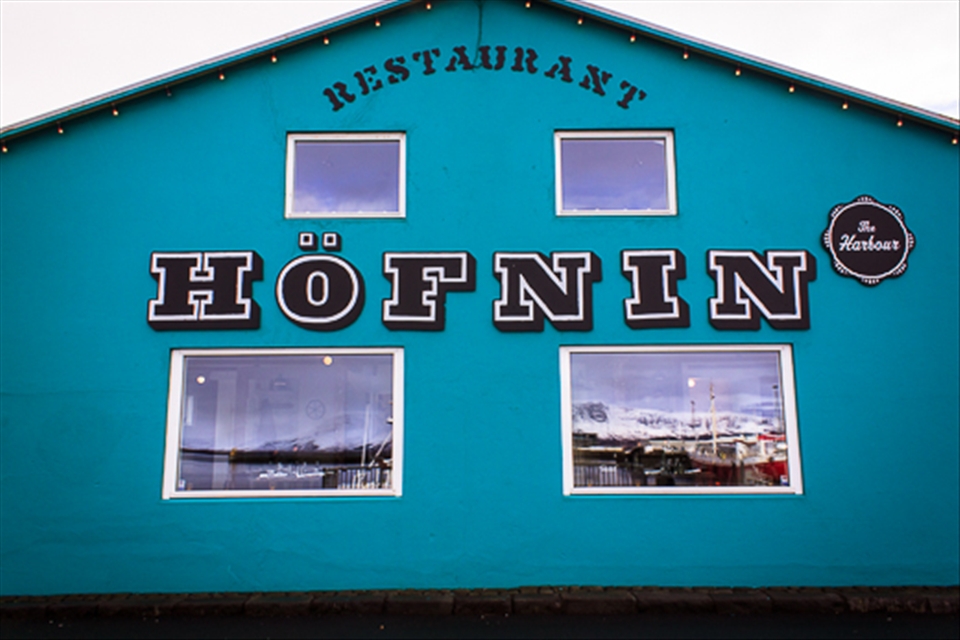 A colourful restaurant in Reykjavik harbour reflecting the Mt Esja