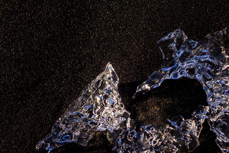 Contrast of Ice sculpture on a bed of volcanic sand at Jökulsárlón