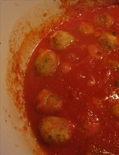 After frying, the pallotte are simmered in a light homemade tomato sauce.