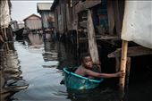 A young boy swims in through dirty oily water of Nigeria's Makoko slum. 30 April: by makoko, Views[924]