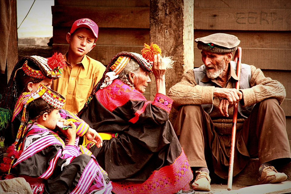 As the day's festivities draw to a close, an elderly Kalash couple surrounded by grandchildren sit on the verandah of their home for a chat. They may be reminiscing about better days, when they were younger, their numbers greater - in the 1951 census of Pakistan, the Kalash population was recorded at 10,000, which by 2012 had dropped to 3,700. They may be ruing the safety of their community, which not only faces pressure to assimilate from their Muslim neighbors, but has also been threatened by the militant Pakistani Taliban. 
<p>
They may be lamenting the gradual loss of their oral traditions. Most Kalash children today go to public schools, where they learn Urdu, the national language of Pakistan. The elders, however, only speak the native Kalasha, according to some scholars the closest modern tongue to Ancient Sanskrit.
<p> 
Although the Pakistani government has applied for UNESCO World Heritage status for the Kalash people, one wonders how long this fabled community can hold together. How much longer can they can preserve their ancient ways, their secrets, thus far protected by the forbidding Hindu Kush, dating to a time and place that only exists in legend?
