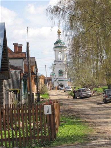 Walking down the dirt streets of the village Plyos. Viewing rows of old wooden homes,  tree lined streets, and beautiful monasterys in the distance. 