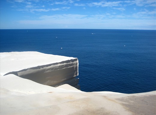 As though walking through a door, the dense heathland along the Track gives way to an ancient plateau; a sandstone iceberg of pure white floats above the Tasman Sea. The shock contrast stuns and you can't help but exclaim to the sea and sky, 