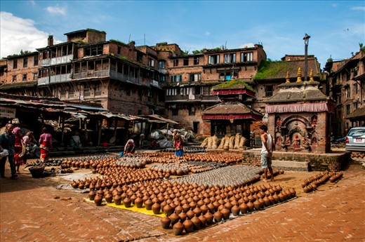 Pottery Square, Bhaktapur, Kathmandu.  These pottery squares are world renowned.  
Here pottery is a family job, the place is common for all the villagers. so everyone in the village work together. their mundane life is part of their religious life too. so even in the common places we can see the temples and buddha statue everywhere in the village. 