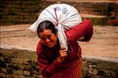 Bhaktapur, A lady carrying loads to pottery square. Despite seeing millions of the tourists every year, people are really humble and content in their hard working daily life. Her smile irrespective of the weight she is carrying has the essence of the Nepal. It never changes the basic nature of their life no matter whoever visits them.: by manikandanav, Views[975]