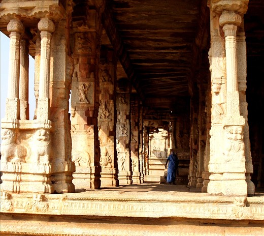 A cleaner at a temple in Hampi