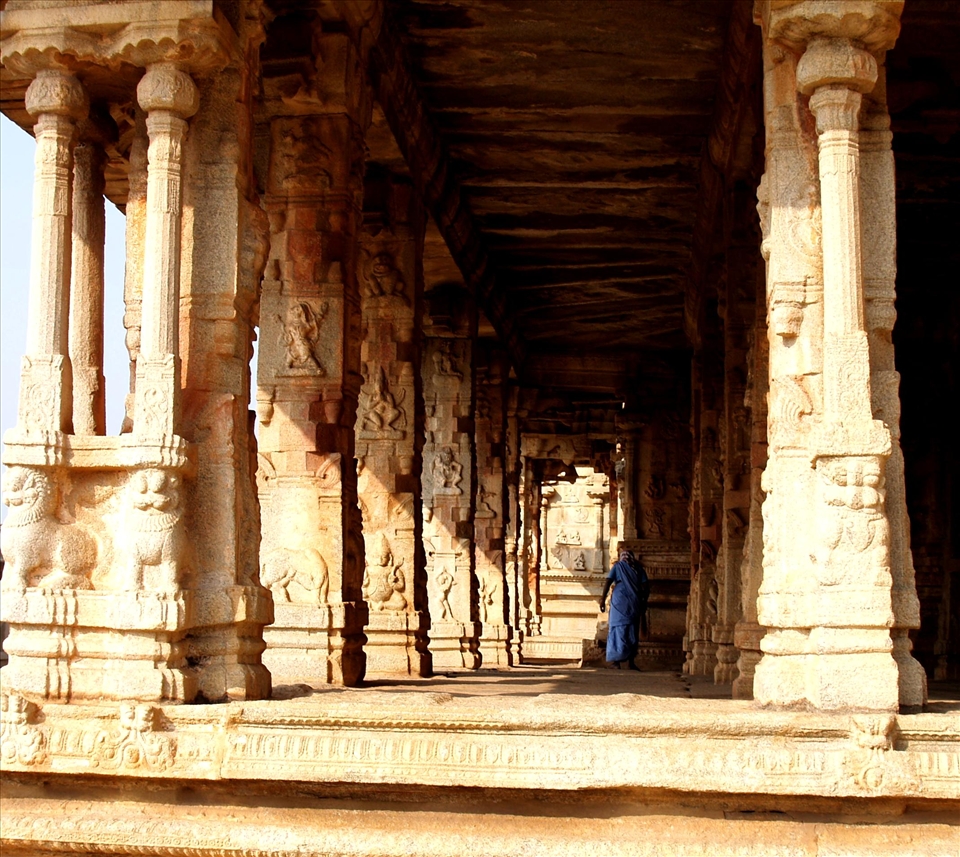A cleaner at a temple in Hampi