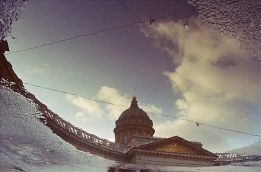 Saint Petersburg, Saint Isaac's Cathedral. Spring arrives and Ice is melting leaving natural mirrors in the street. 