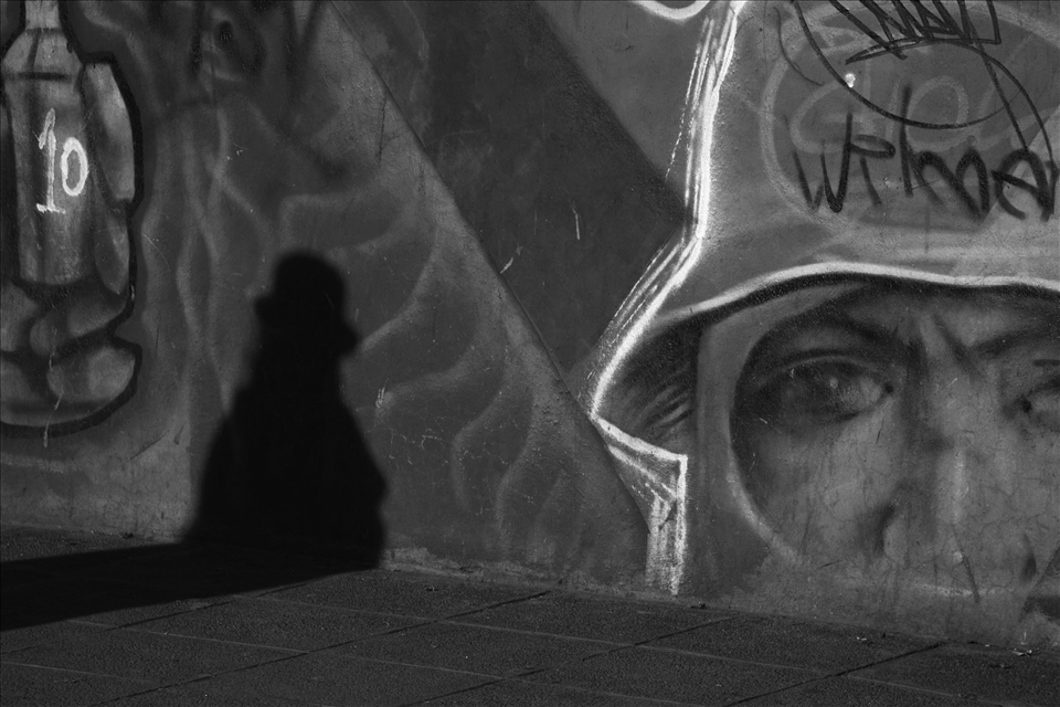 A shadow of a woman walking on the street. 