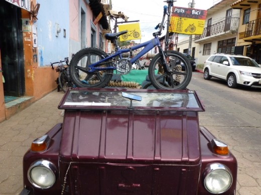creative car in front of a cycling shop in San Cristobal