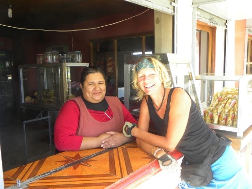 Sweet woman selling sweet doughnuts on the side of the road. 