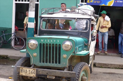 From the lonely Planet:
If you spend any time at all in the Zona Cafetera it is highly probable that you will take at least a couple of rides in a classic WWII jeep. 
These veterans don't just look great parked in formation around rural parts of the Zona C. Willys are used to transport everything from passengers to pigs, platano, furniture and of course coffee. And unlike buses, a Willys jeep is never really full- don't be surprised if your driver packs in 16 passengers or more.
The first jeeps to arrive in were army surplus models sent from the USA in 1950 in order to sell the vehicles to farmers in the Zona C, a kind of traveling jeep show was created with expert drivers maneuvering the vehicles up and down the stairs in front of the churches and moving loads through obstacle courses in the plazas. The locals were sold instantly- and so began a love affair that lasts to this day.
Willy jeeps are such an integral part of rural Colombian culture that a 