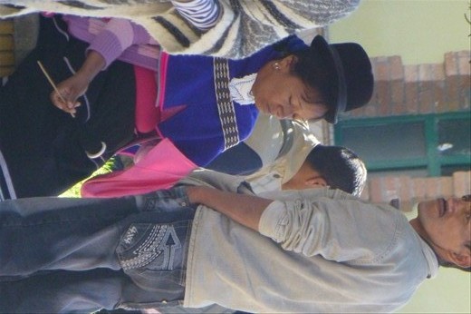 downtown plaza - indigenous woman spinning yarn all the time.