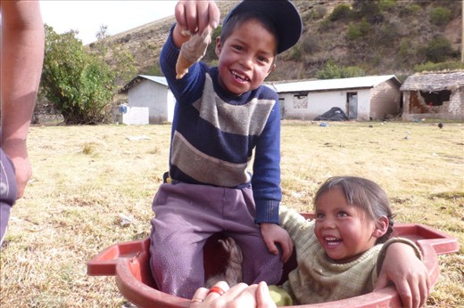 peruvian kids tarring a doll apart....luckily it isn't the puppy...