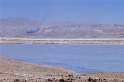 biggest copper mine in the world: Chuquicamata. It sucks the dry surrounding desert even dryer: this lake is created by the mine for its purpose. 