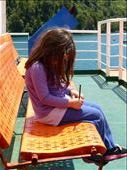 girl on a ferry keeping busy.: by margitpirsch, Views[191]