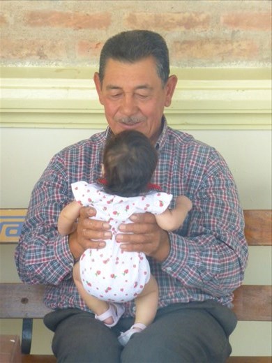 granddad playing with the baby at a bus stop heading north 