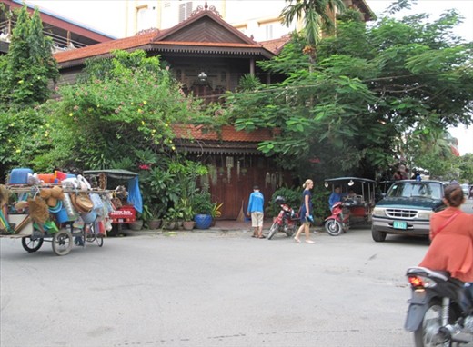 Central area street.  Restaurant screened by potted plants