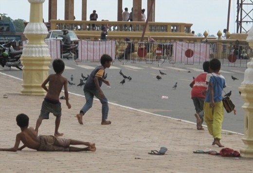 Boys playing soccer on a quiet street near Royal Palace