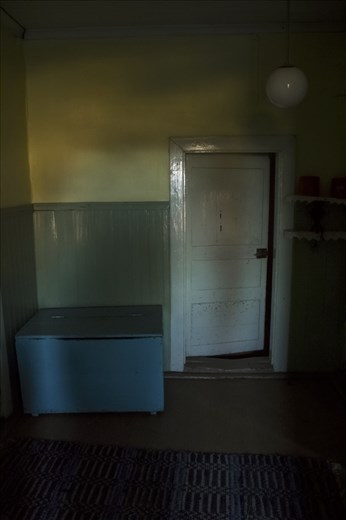 Afternoon sun casts shadows inside an abandoned house. 