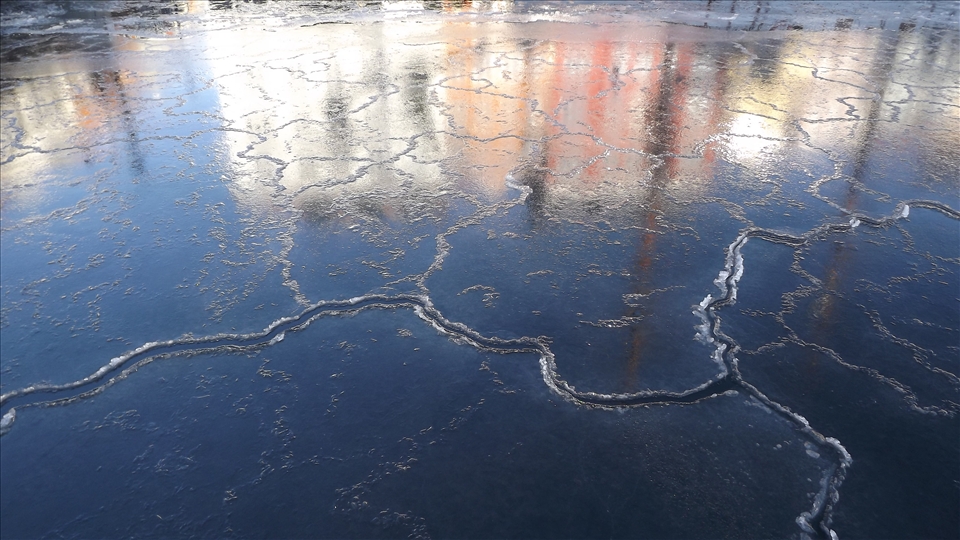 Buildings of the Nyhavn street in Copenhagen reflected in ice of the channel