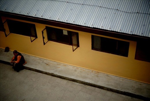 a lady chanting prayers, daramshala