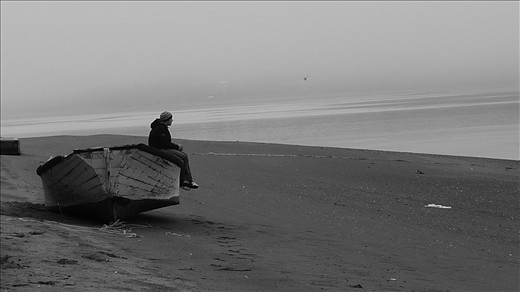 A young man in the lonely beach of the island Chelín