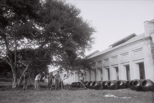 A regular chore in their regular longyi, a sarong-like garment for Burmese men. 