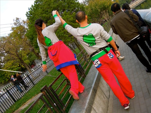 Wearing matching outfits is the latest trend among young couples in China. This couple shows off their style as they regally walk outside The Forbidden City in Beijing. 