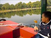 A little boy hold tightly onto his hand-made candy-on-a-stick as he enjoys a boat ride through the Summer Palace in Beijing. : by marietornquist, Views[481]