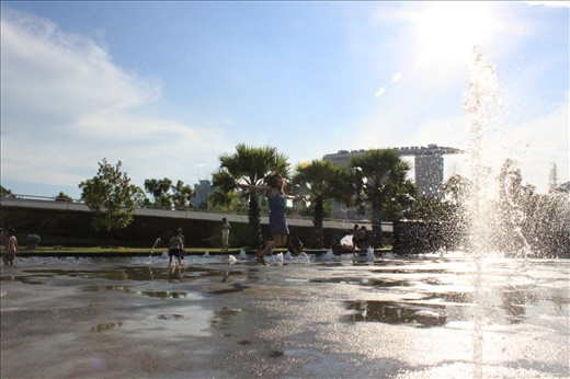 Freeze in time. Walking down the loop, we will find a nice water feature, its attractive playful design surprises us by spraying water beneath our feet at random place. This is a   place to get wet and cool down in a very hot sunny day. The girl in the middle of the photo express herself by jumping in a right timing when the water sprayed a few feet ahead my camera. 