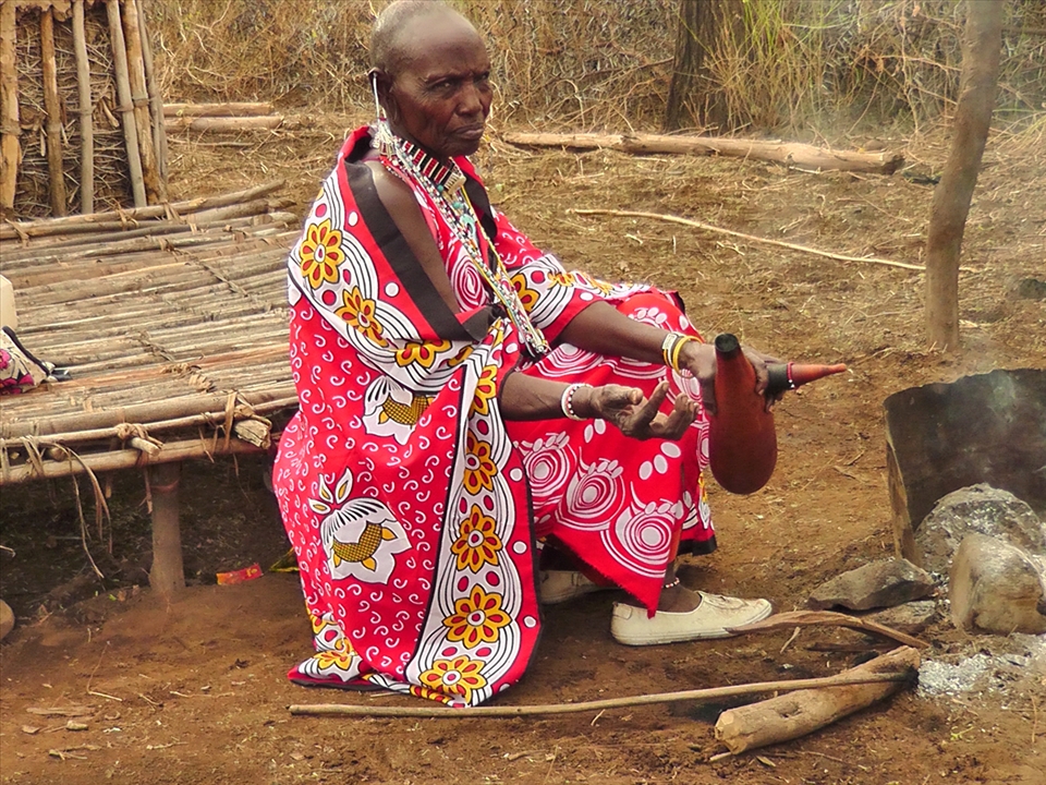 3.	An older maa woman preparing a gourd to store milk, one of the maa main meals