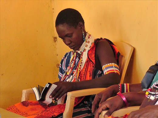 4.	One of the uneducated women looks through the books in the resource center  
