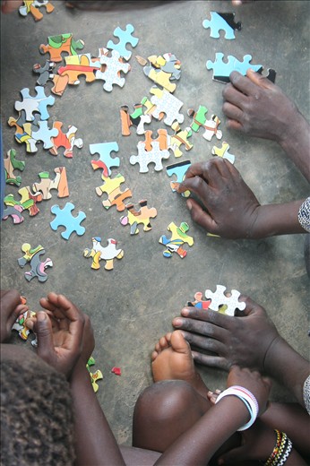 Toessé, Burkina Faso. School recess, in love with puzzle