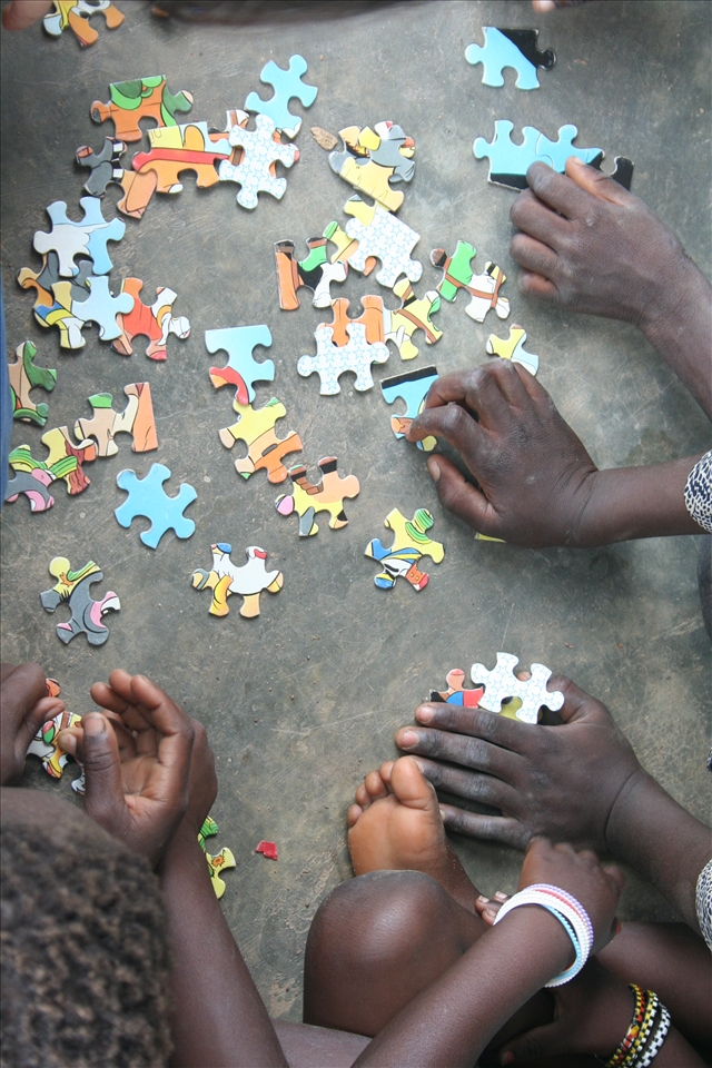 Toessé, Burkina Faso. School recess, in love with puzzle