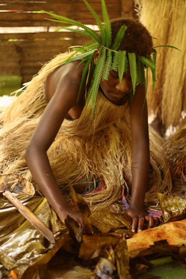 Woman preparing the laplap, the typical dish of the country, made with cassava, banana and coconut. Other foods can be added, like meat or fish according to the regions. Lekalangia, Tanna, Vanuatu.