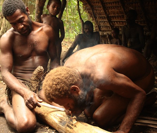 Tribal man making fire with sticks in the nakamal, the typical place where they meet in the village or tribe to discuss about daily problems or to take important decisions with a Kava drink. Important ceremonies also take place in the nakamal, like mariages, for example. In Tanna, woman are not allowed to go to the nakamal and they can't drink Kava. Lekalangia, Tanna, Vanuatu.
