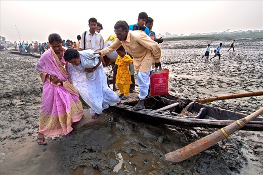 Low Tide Time Boats a not moving , relatives are helping a  patent to cross  