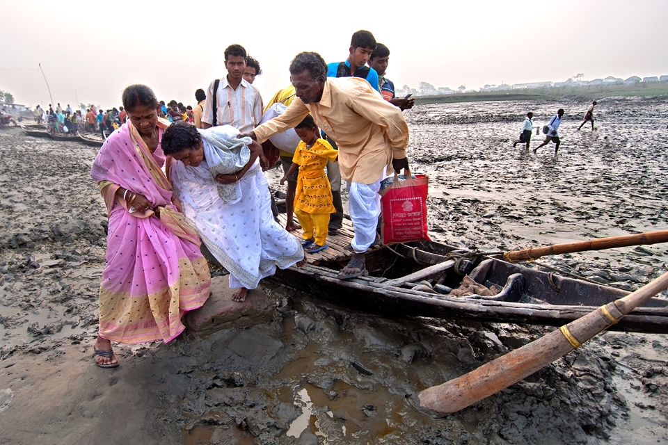 Low Tide Time Boats a not moving , relatives are helping a  patent to cross  