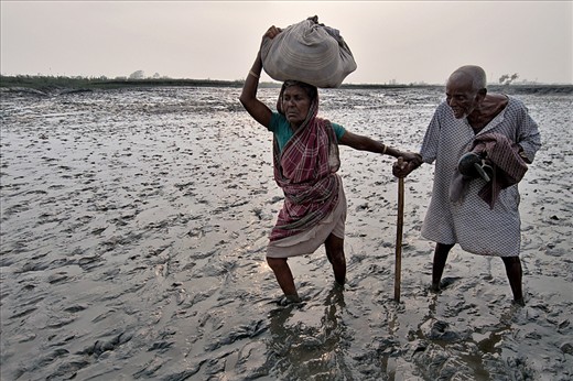 Muddy Area at low tide time a Old Lady  crossing  the river bed with Husband
