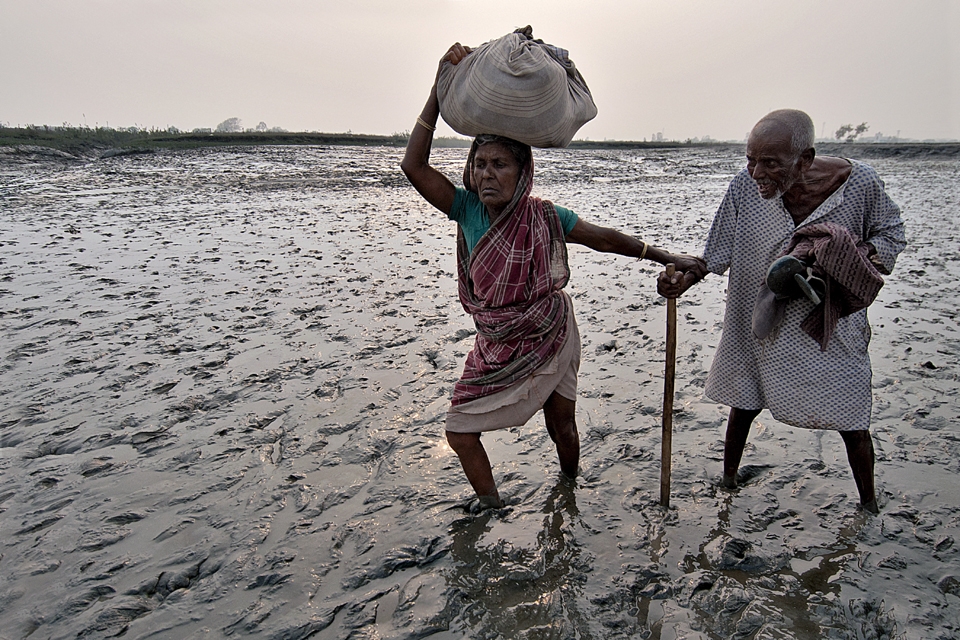 Muddy Area at low tide time a Old Lady  crossing  the river bed with Husband