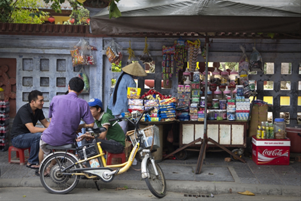 Street stalls throughout Vietnam not only sell an array of goods they also act as a place to socialize. After a hard day selling on the streets themselves, workers often spend hours at a time hanging around stalls like this, playing cards, drinking, laughing and catching up on all the days gossip.
