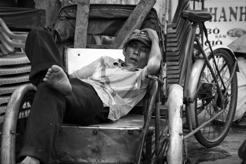 Cyclo riders in Vietnam spend hours on end transporting passengers around town on their rickety bikes. They pedal around all day calling out ‘Cyclo, Cyclo’ to any potential customer. The drivers look so at home on their pedal powered taxis and it is a pretty common sight to see them catching up on sleep in between customers.