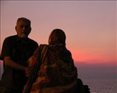 Mumbai is actually an island connected to mainland Maharastra by a series of roads. This is at the hook of Mumbai at Girgaum Chowpatty (Girgaum Beach). The whole stretch has this ongoing bench where hundreds of people come together and sit to see the beautiful pink, Bombay sunset and stay happily until twilight. I saw this man help his wife sit on the bench as it is a bit of an effort to get up.: by mattandmed, Views[391]