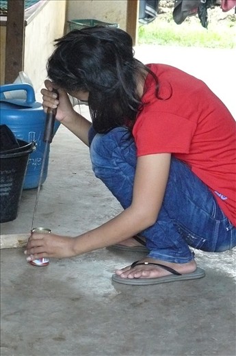 Trying to open a tin of mackerel with a machete!